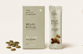A box and a daily sachet labeled Nourish Ritual by My Store are shown with Mamra almonds, seeds, and nuts placed beside them on a light background.