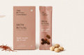 A pink box and matching packet labeled The Strength Ritual from My Store, with some round tablets, walnuts, and loose herbs or spices displayed in front—perfect for incorporating into your nourishing morning routine or Strength Ritual.